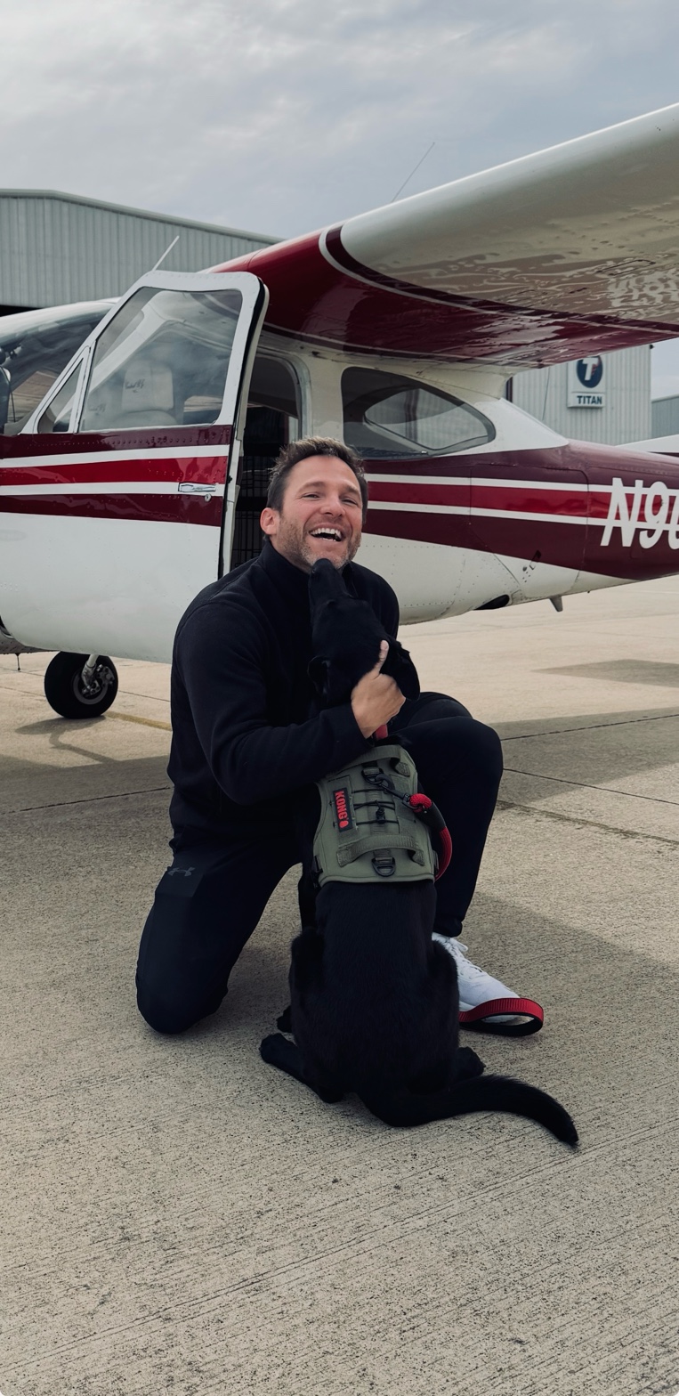 Founder kneeling with rescue dog in front of Hope